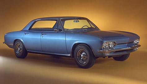 Three Quarters View of Blue Chevy Corvair on a Yellow Space