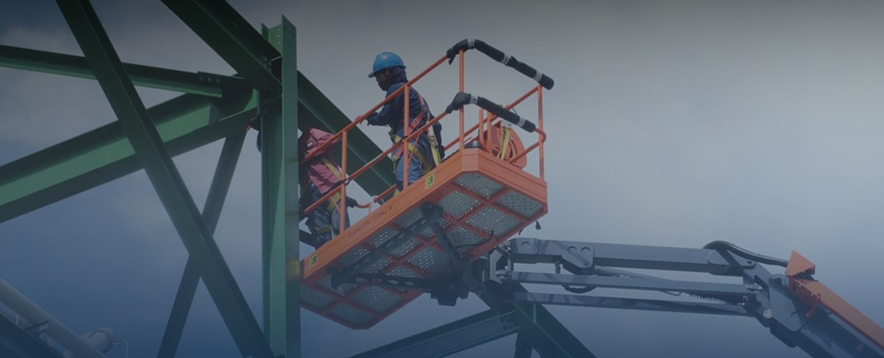 Two Construction Workers Going up to a Beam in a Lifter