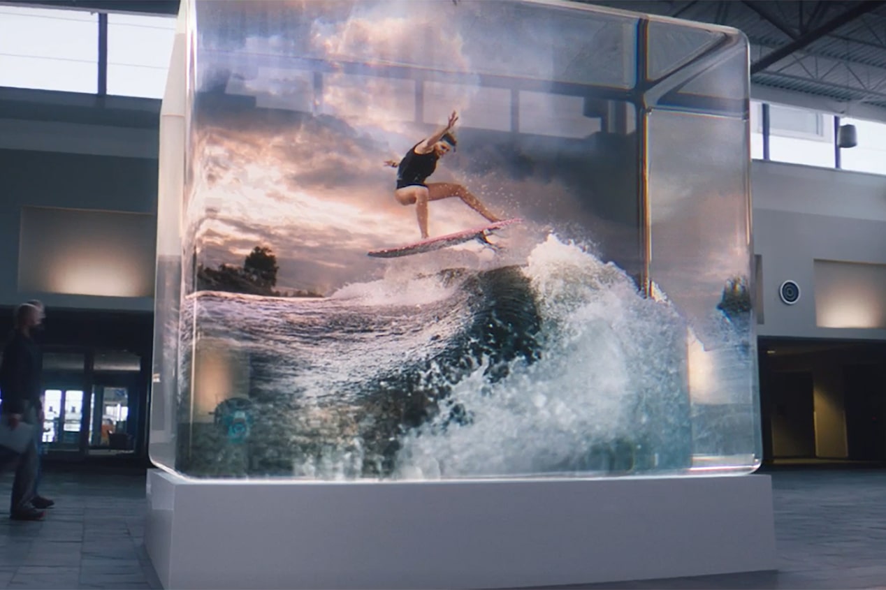 A Person Surfing on Water Projected Encased on a See-through Box