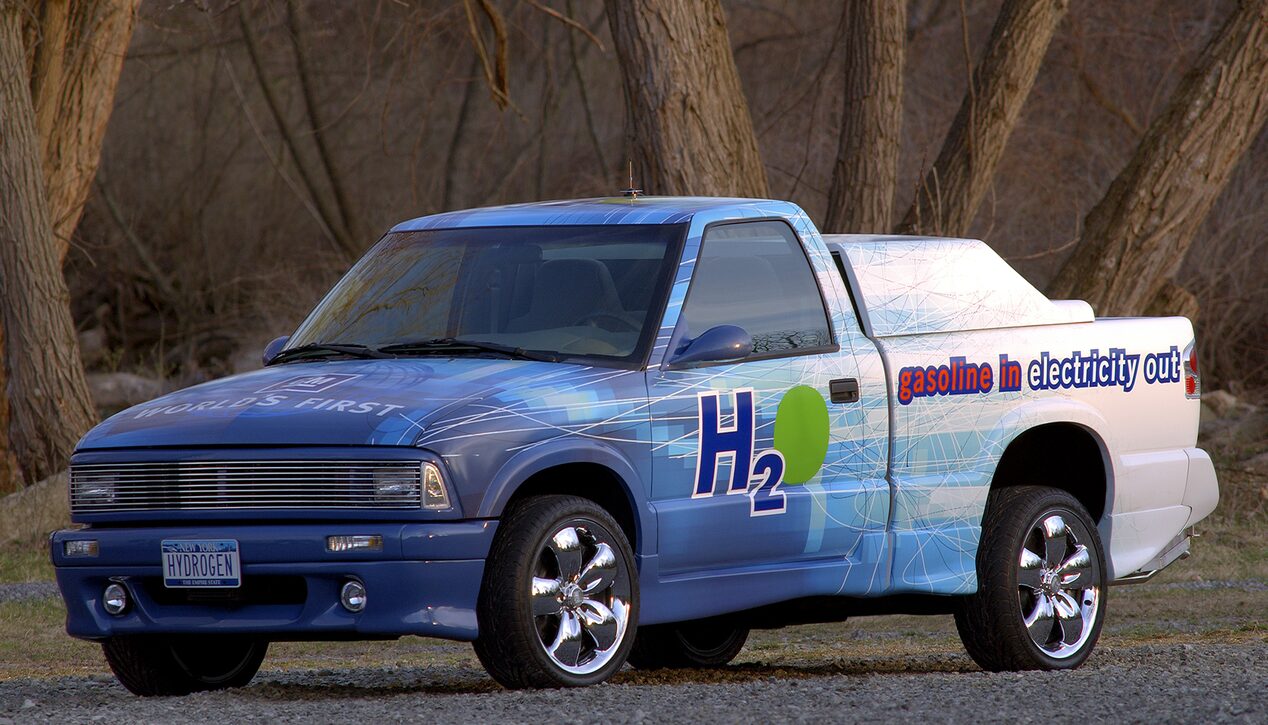 A Blue and White 2001 Chevrolet S-10 Truck Powered by Fuel Cell Technology with "H20" Written on the Driver's Side Door in Stylized Graphics