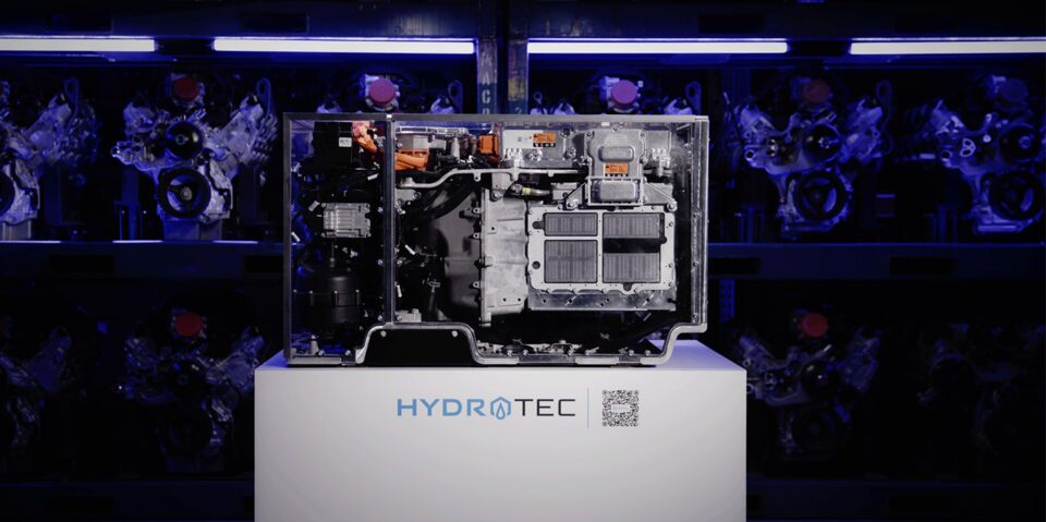 Video Thumbnail Featuring a HYDROTEC Fuel Cell System on Display, Illuminated With Blue Lighting, Against a Background of Multiple Engine Components