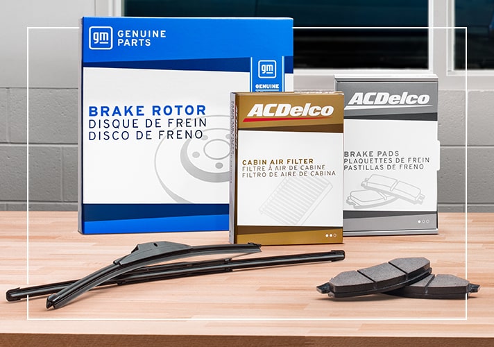 Close up of a ACDelco Brake Rotor, Cabin Air Filter, Brake Pad and Windshield Wipers on a Work Bench