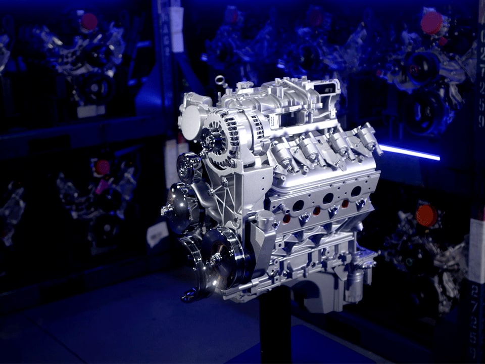 Video Thumbnail Showcasing a High-Performance Engine With Intricate Mechanical Components, Illuminated With Blue Lighting, Against a Background of Engine Part