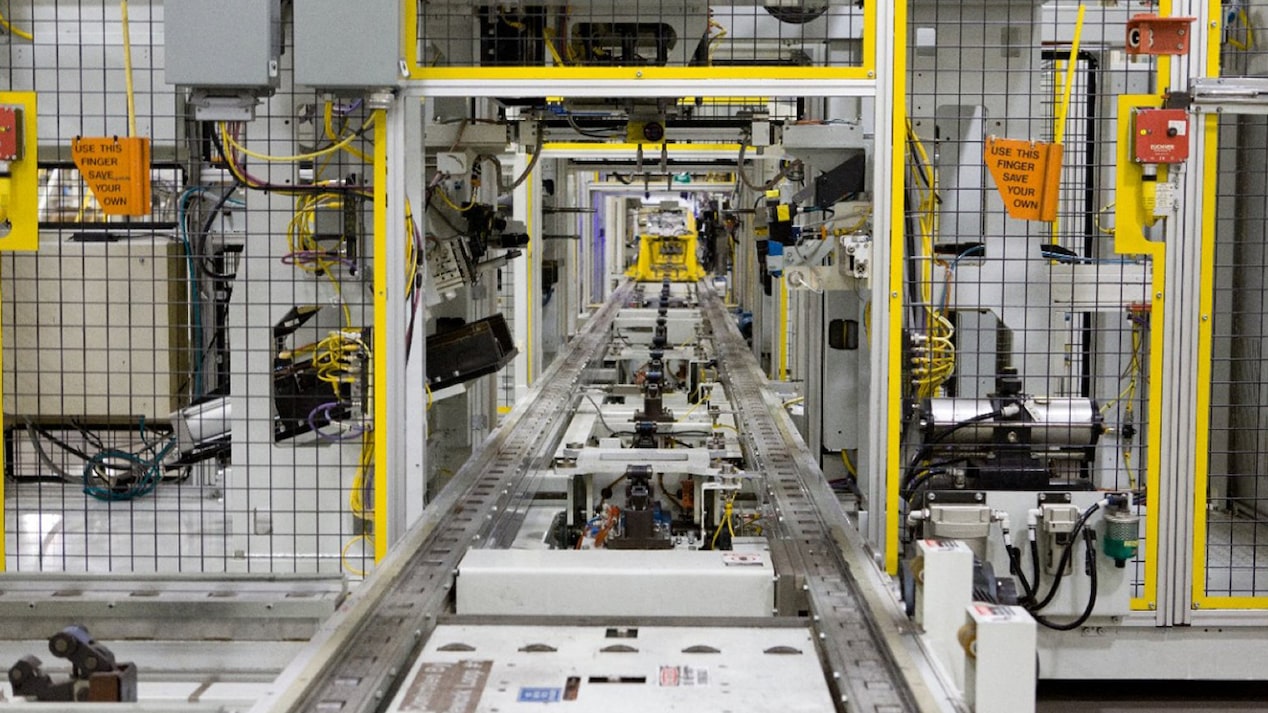 A Shot of a Long Conveyor Belt Carrying Engine Parts in a Factory