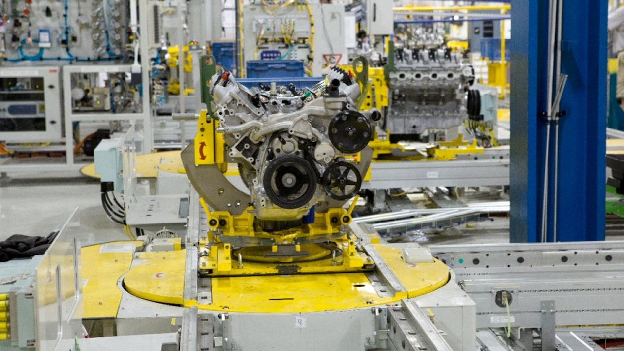 An Engine Placed on a Yellow Steel Plate in a Factory