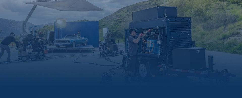 A Crew Works on a Hydrogen Fuel Cell Station Outdoors Under a Sunny Sky